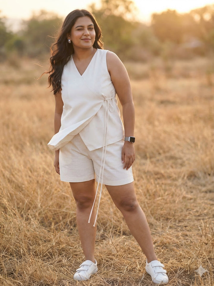 Woman in a white outfit standing in a field with a sunset background [Buy Summer Co Ord Set for Women Online]